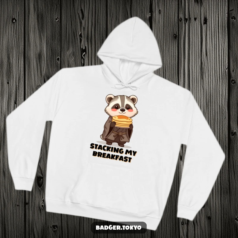 Funny Kawaii badger in a rustic kimono proudly balancing pancakes, a cozy and humorous hoodie design.