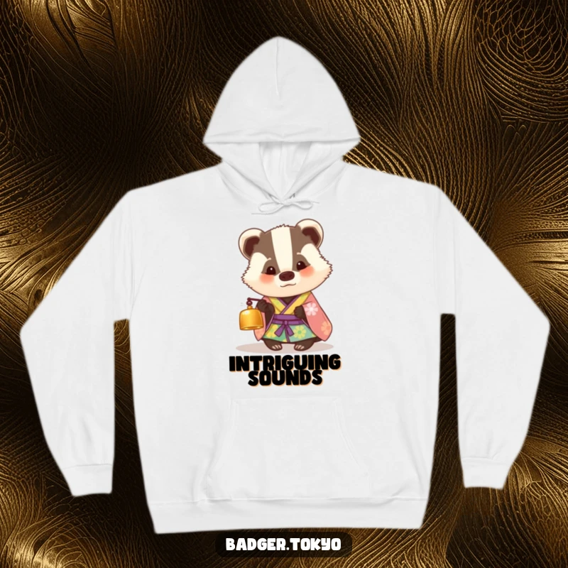 Funny hoodie with a badger in a colorful kimono looking curiously at a tiny bell, offering warmth and a humorous sense of wonder.