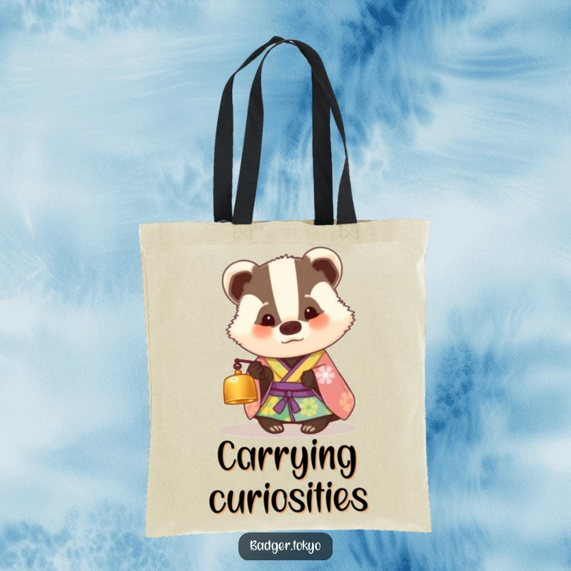 Funny tote bag with a badger in a colorful kimono looking curiously at a tiny bell, perfect for carrying items with humorous intrigue.